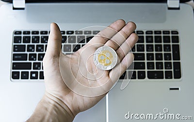 Ripple coin on a laptop keyboard closeup on a miner hand. Blockchain mining. Digital money and virtual cryptocurrency Editorial Stock Photo