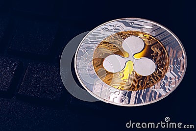 Ripple cryptocurrency crypto currency. Silver Ripple coin with gold Ripple symbol. Ripple XRP cryptocurrency Editorial Stock Photo