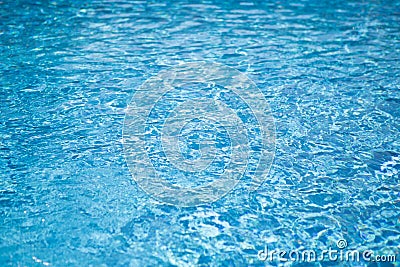 Ripple water in swimming pool with sun reflection. Blue water abstract background Stock Photo