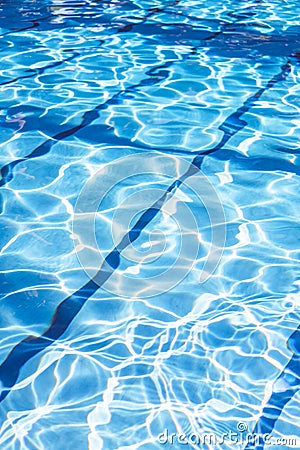 Ripple Water in swimming pool with sun reflection. Summer day at swimming pool. Background and texture concept.Vertical. Stock Photo