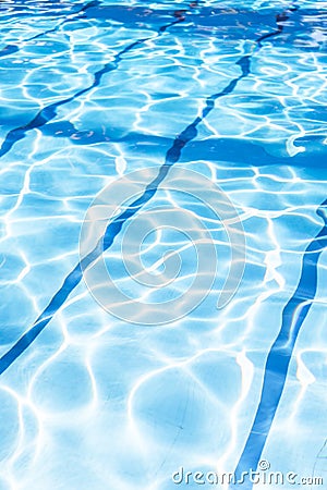 Ripple Water in swimming pool with sun reflection. Summer day at swimming pool. Background and texture concept.Vertical. Stock Photo