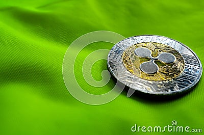 Ripple XRP coin on green background Editorial Stock Photo