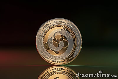 Ripple XRP crypto coin placed on reflective surface in dark background Editorial Stock Photo