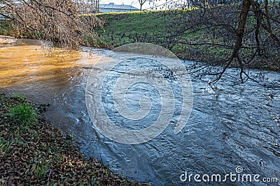 Rised water level in the creek after snow melted. Flood risk. Global warming concept Stock Photo