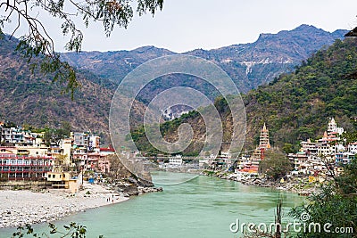 Rishikesh, holy town and travel destination in India. The Ganges River flowing between mountain from the Himalayas Stock Photo