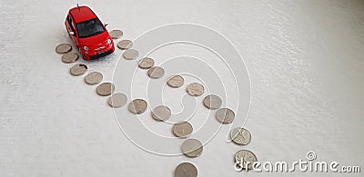 Red fiat 500 abarth toy starting its way on road line made of one Israeli shekel coins Editorial Stock Photo