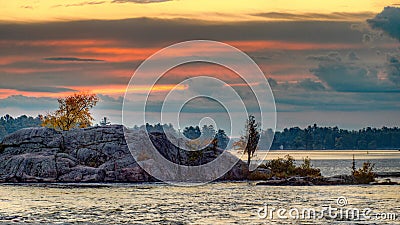 Sun Rising Over A Rocky Island On Stoney Lake At Burleigh Falls Stock Photo