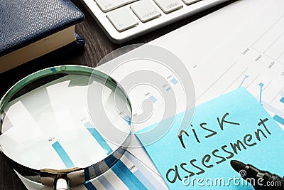 Risk assessment. Magnifying glass and documents on a table Stock Photo