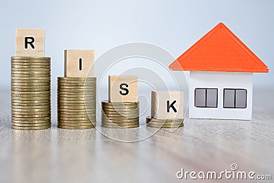 Risk the coin and the orange house Investment risk concept Build houses, choose risks, invest in housing business Stock Photo