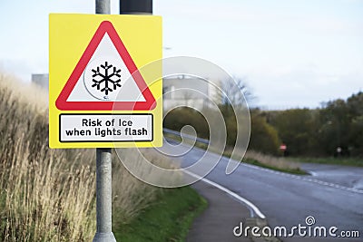 Risk of ice when light flashes winter road safety sign Stock Photo