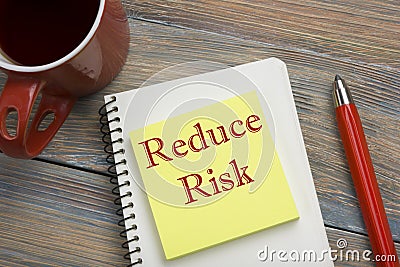 Risk management strategies - avoid, exploit, transfer, accept, reduce, ignore. Office desk table with notebook, pen and Stock Photo
