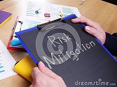 Risk Mitigation is shown on the conceptual photo using the text Stock Photo
