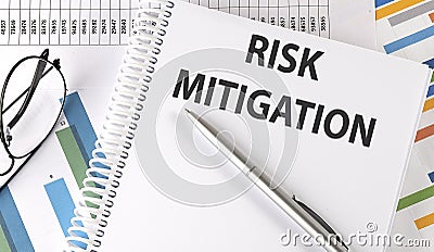 RISK MITIGATION text , pen and glasses on the chart,business concept Stock Photo