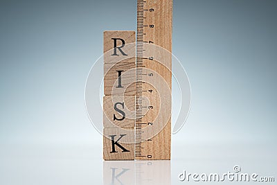 Risk Word On Blocks Near The Ruler On Reflective Desk Stock Photo