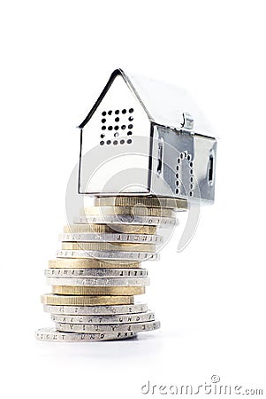 Risky real estate investment, small silver house on a slanted st Stock Photo