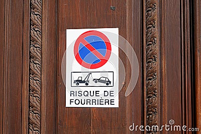 Risque de fourriere sign evacuation french text means risk car impound front of personal home entrance door garage Stock Photo