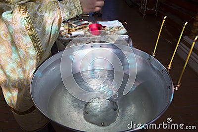 The rite of baptism. Priest prepare to baptize the child. Stock Photo