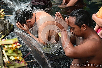 The ritual purification in the temple pond. Tirta Empul. Tampaksiring. Gianyar regency. Bali. Indonesia Editorial Stock Photo