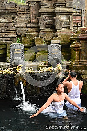 Ritual purifying bath in the temple pond. Tirta Empul. Tampaksiring. Gianyar regency. Bali. Indonesia Editorial Stock Photo