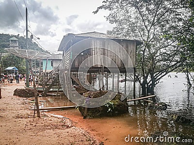 The River Amazon and houses on stilts on the river bank, a traditional Brazilian way to live near the river. Editorial Stock Photo
