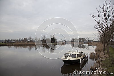 River amstel and small boat in winter not far from Amsterdam Stock Photo