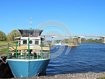 River Atmata, ships and bridge, Lithuania Stock Photo