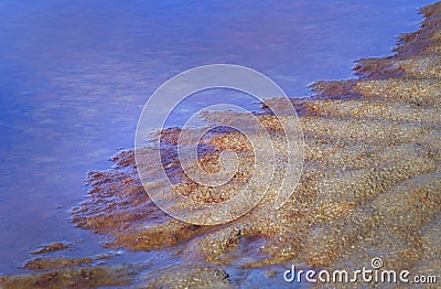 River bank giving beautiful texture with red coloration by the iron holding water Stock Photo