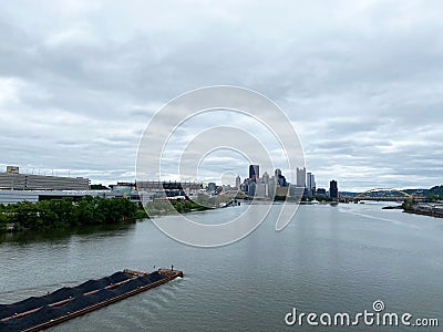 River, Barge, and City Center in Pittsburgh Pennsylvania Stock Photo