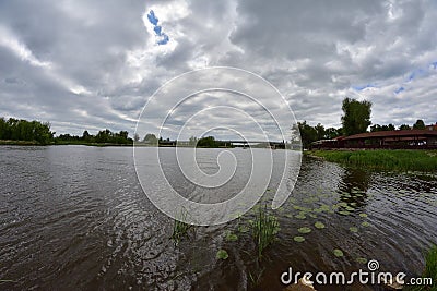 River bend, undefined building far on the other bank. Stock Photo