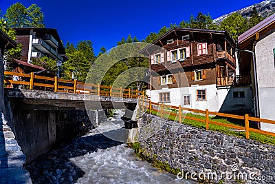 River and chalet in swiss village in Alps, Leukerbad, Leuk, Visp Stock Photo