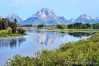 A river in Colorado reflects snow capped mountains. Stock Photo