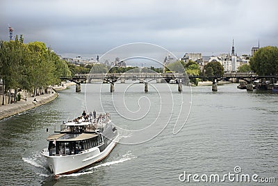 River Cruises sailing bring travelers passengers tour Paris city at riverside of Seine river Editorial Stock Photo