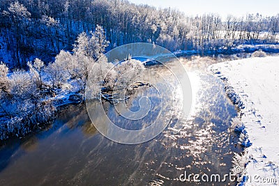 River curve on sunny morning in winter, aerial landscape. Temperature contrast concept Stock Photo