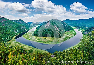River envelops the horn peak in the ring. Aerial view of Canyon of Rijeka Crnojevica river, Skadar lake lacation. Impressive summe Stock Photo