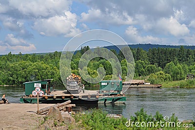 River ferry transports timber. Stock Photo