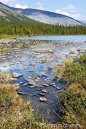 River flooding with lake in valley of the Khibiny massif at summer, sunny warm weather with calm water. The Kola peninsula, Russia Stock Photo