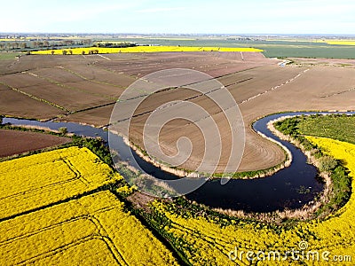 River flowing among rapeseed fields on Zulawy Wislane Stock Photo