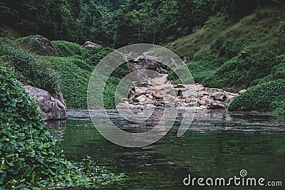 River flows over rocks in this beautiful scene Stock Photo