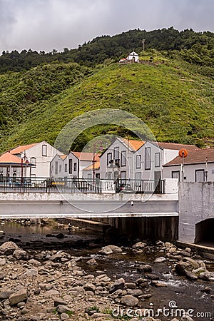 River, houses and a hill, Faial da Terra, Azores Stock Photo