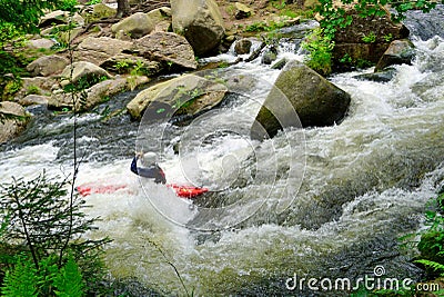 River kayaker going over waterfall in the forest Stock Photo