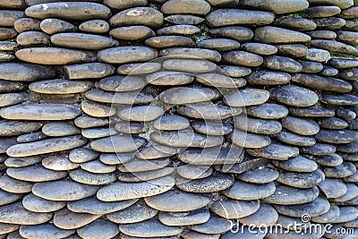 River pebble gravel round stone wall Stock Photo