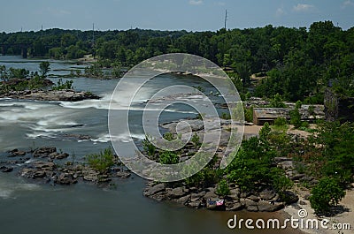 River rapids in motion with woods and green around it Stock Photo