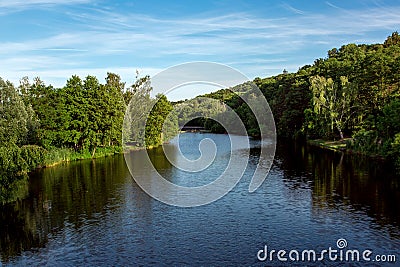 The river recedes into the distance on the shore. Stock Photo