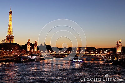 River Seine Paris by night with Alexandre III bridge and Eiffel Tower illuminated france Editorial Stock Photo