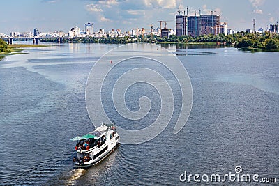 A river tram carries tourists along the Dnipro River along the left bank of Kyiv, top view Stock Photo