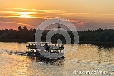 River tram at sunset in the city park of culture and recreation in the city of Uralsk. Stock Photo