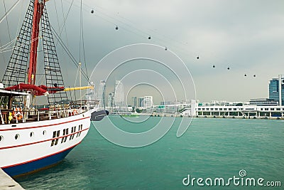 River view in Singapore with sailing boat in foreground against black clouds Stock Photo