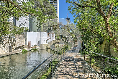 River Walk in San Antonio Texas flanked by trails and buildings on a sunny day Stock Photo