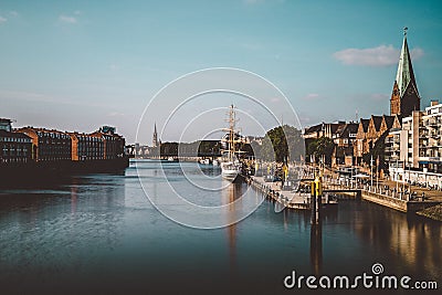 Of the river Weser and the historic Schlachte waterfront with the spire of St. Martini church Stock Photo