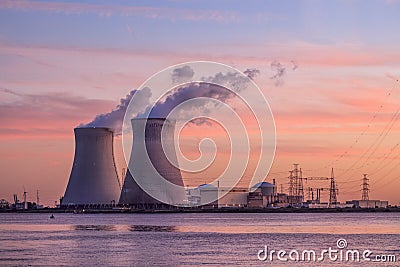 Riverbank with nuclear power plant Doel during sunset, Port of Antwerp, Belgium Stock Photo